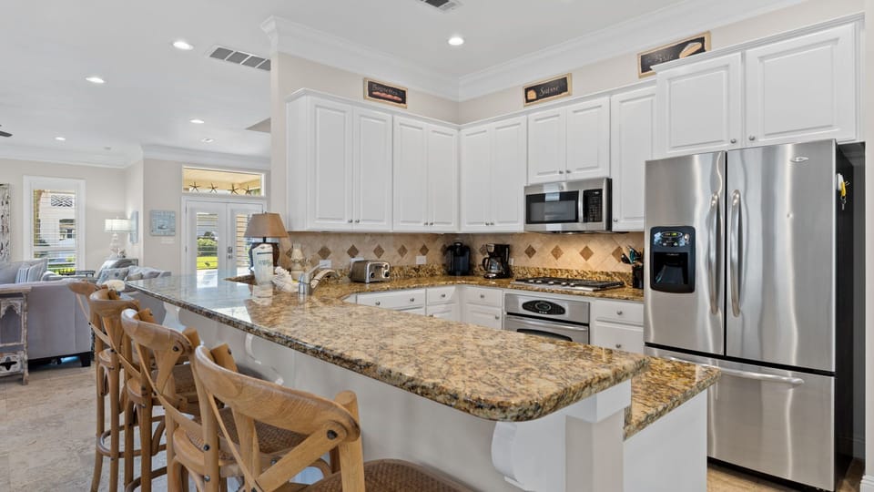 Large kitchen with separate pantry and pass-through to screened porch.