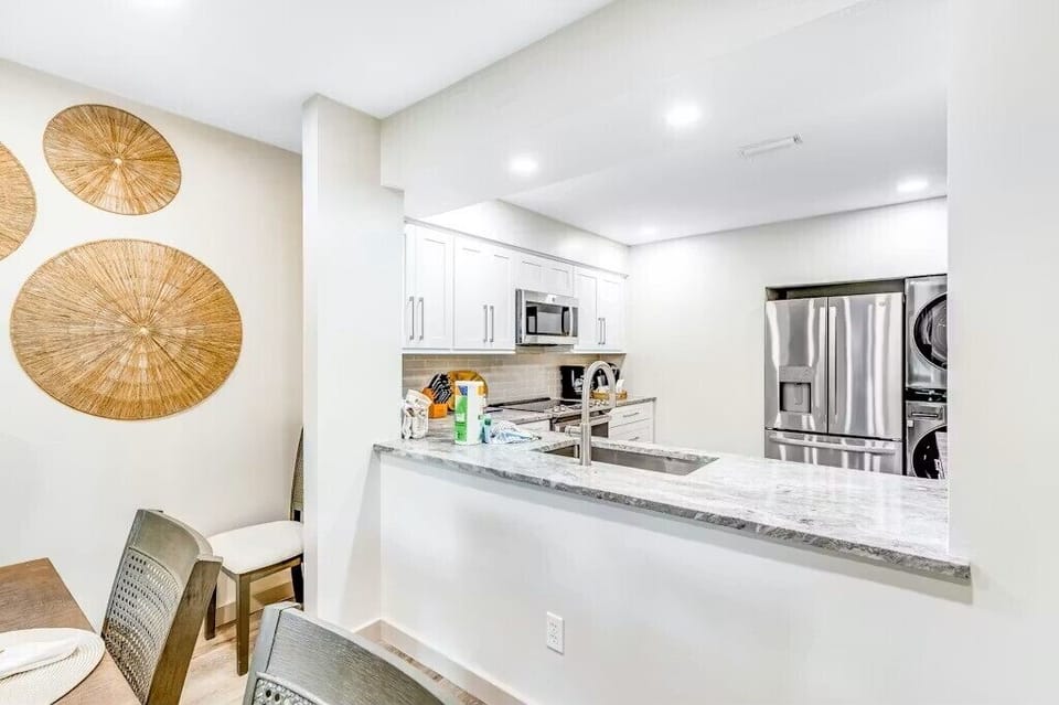 Kitchen has an open pass thru for serving food all the while being part of the conversations and activities from any where in the dining-living room area.