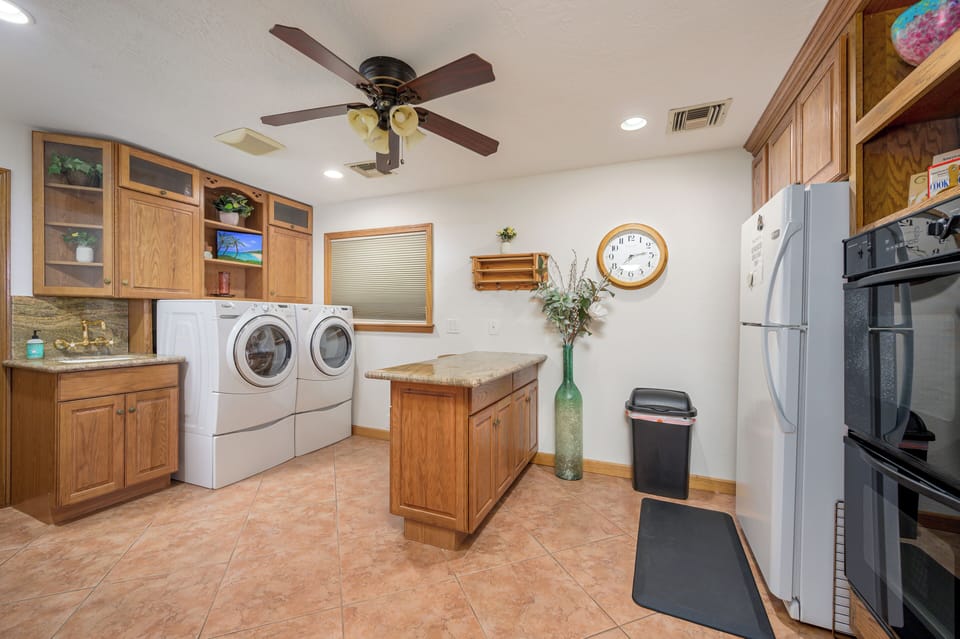 Large laundry room with sink, refrigerator and extra oven
