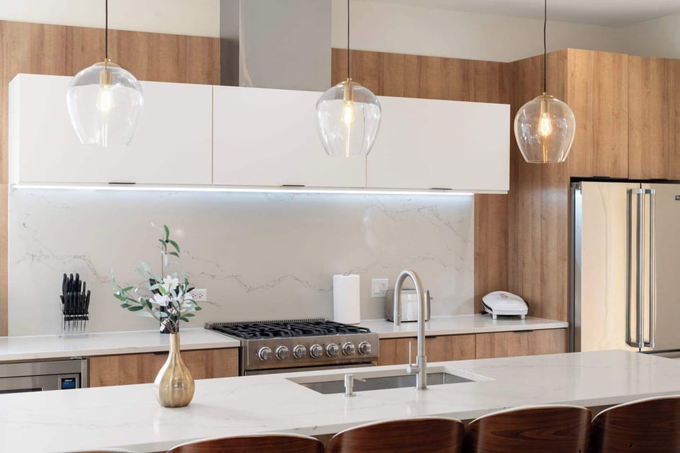 Sleek kitchen layout w/ warm wood tones & plenty of prep space to spread out comfortably.