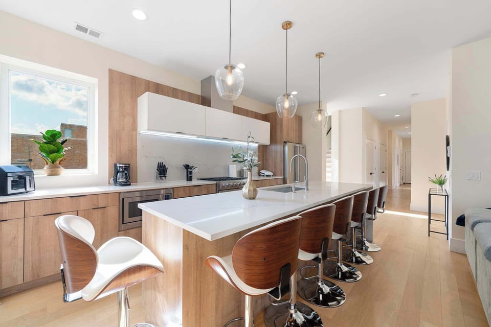 Wide kitchen counters set the stage for cooking, plating, or lingering chats over coffee.