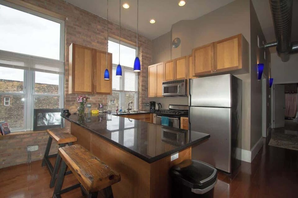 Well-equipped kitchen w/ warm wood finishes & easy flow into the living area.