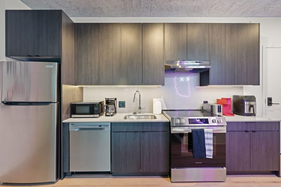 Sleek kitchen w/ clean lines, integrated appliances, & a polished, contemporary look.