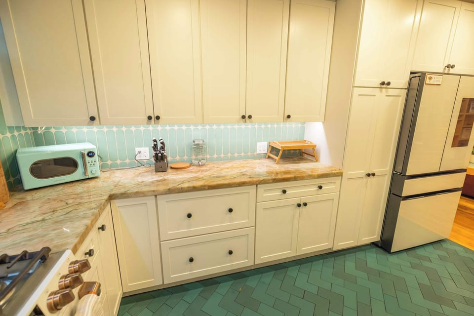 Stylish tile backsplash and warm countertops add charm to this inviting cooking space