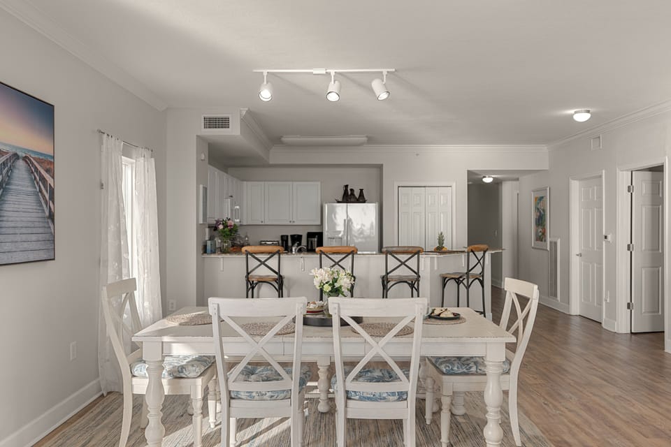Open-concept dining and kitchen layout with breakfast bar seating—perfect for gathering, serving, and staying connected.