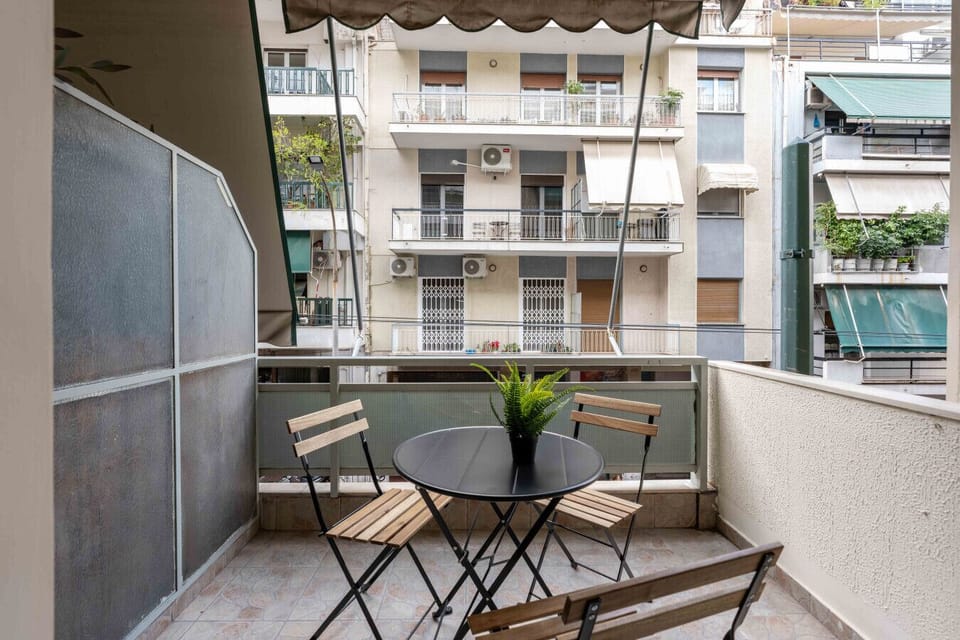 Private balcony with outdoor table and chairs.