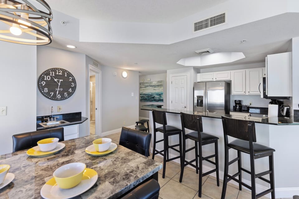 Your fully-equipped kitchen features granite counters, stainless appliances, and bar seating where you'll enjoy morning coffee and casual meals.