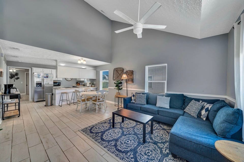 Walk in to the open concept living area with plush furnishings and TV