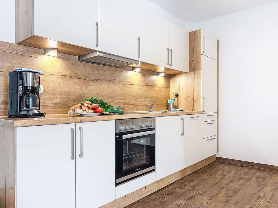 Flooring, Countertop, Wood, Kitchen, Cabinetry, Floor, Kitchen Appliance, Interior Design, Major Appliance, Wood Flooring