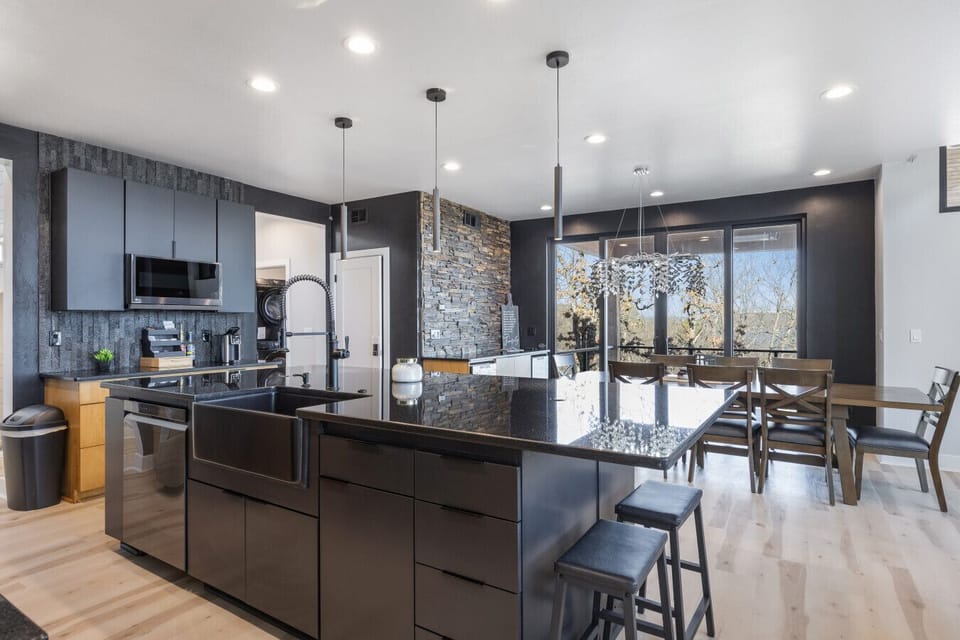 Fully stocked open concept kitchen with bar seating for 6 and dining table with seating for 8