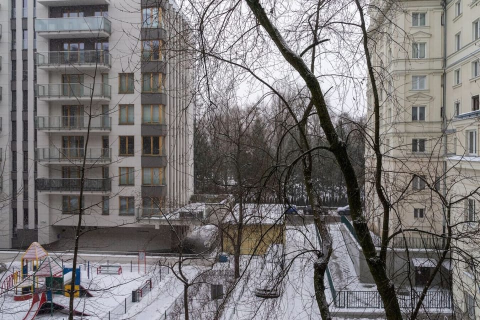 Balcony View – Overlooking a Quiet Courtyard with Playground and Surrounding Greenery | Book Now with RENTUJEMY.COM