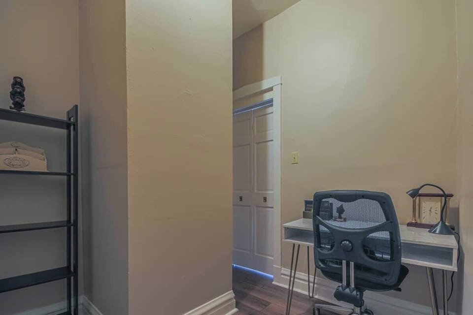 Compact office space w/ desk, chair, & a quiet setup for productivity.