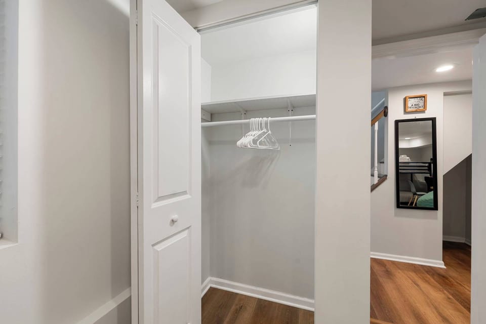 Organized closet view w/ shelves & hanging space for longer stays.
