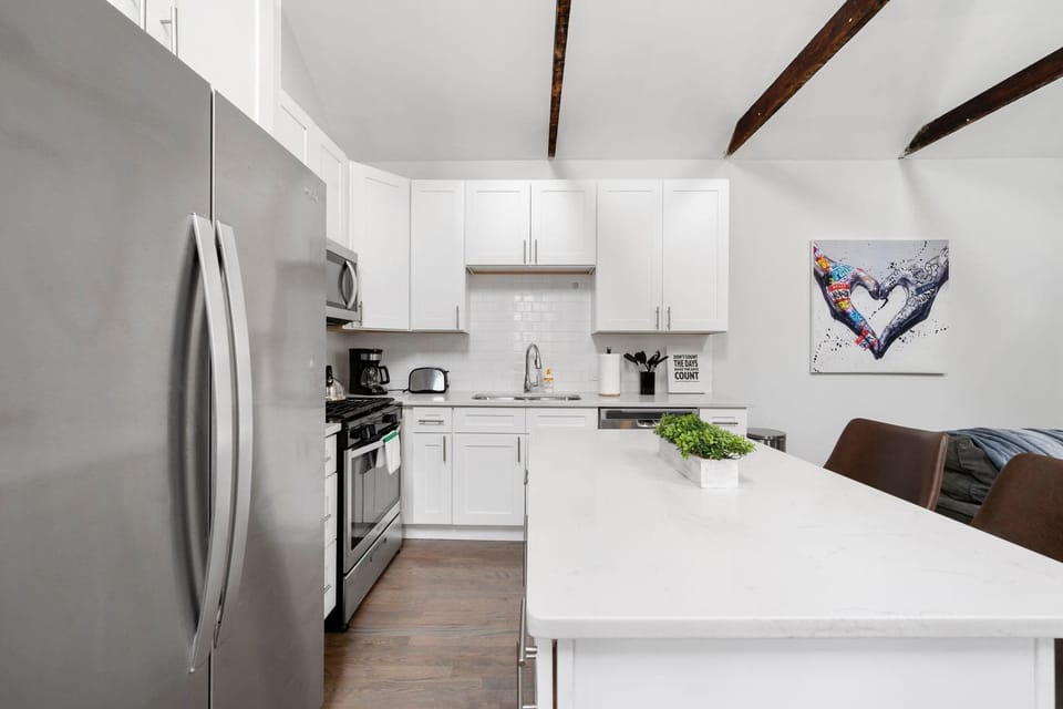 Another bright kitchen view that keeps things open, clean, & efficient.