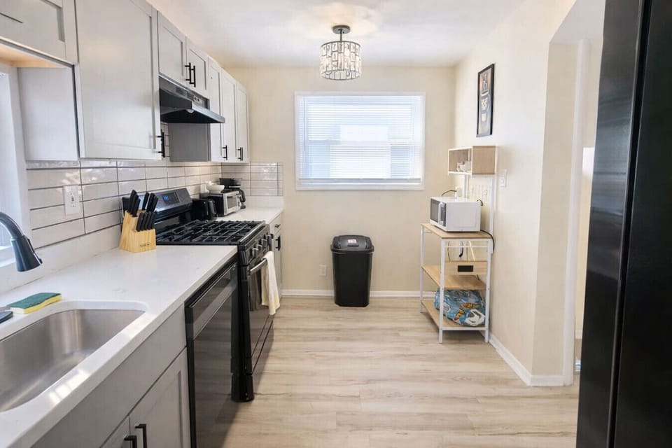 Enjoy a sun-drenched space to start your day. This contemporary kitchen offers a clean, organized layout and premium finishes for a seamless stay.
