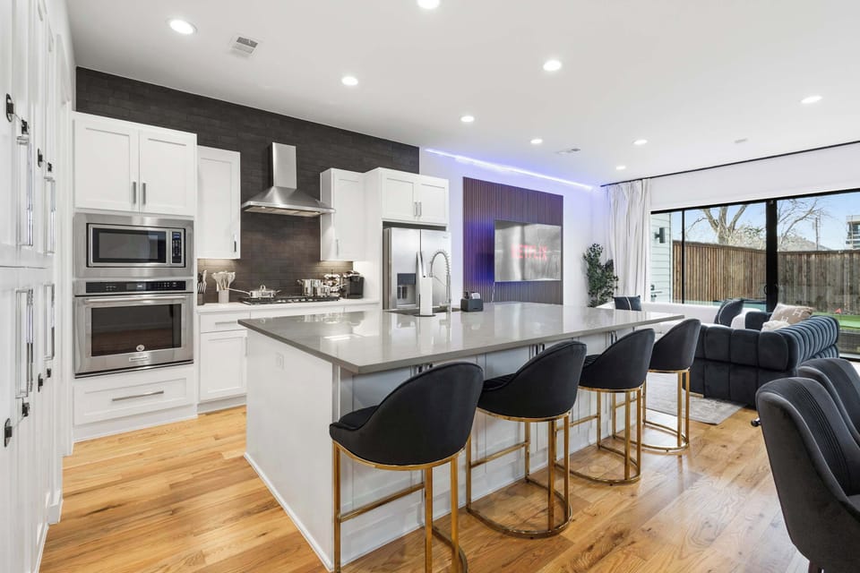 The spacious kitchen island offers extra seating for casual meals, morning coffee, or catching up while dinner is prepared. Perfect for groups who love to stay connected while cooking and entertaining.