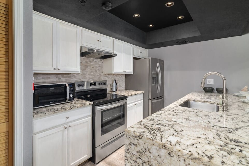 Gourmet kitchen featuring granite islands and integrated appliances.