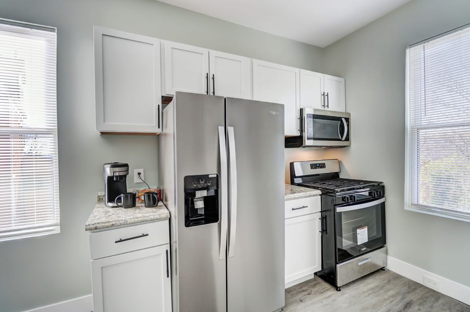 Full kitchen with modern appliances and complete dinnerware set.