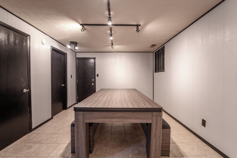 Bright bonus room with large game table and modern lighting