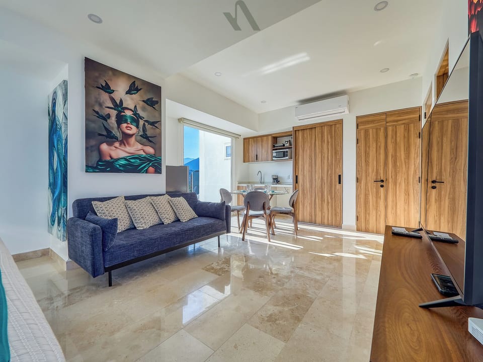 Bright, open living space with easy flow to the kitchen and dining area, perfect for relaxing and sharing meals.
