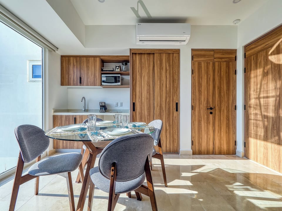 Cook and dine in a fully equipped modern kitchen with sleek finishes and a dedicated dining area filled with natural light.