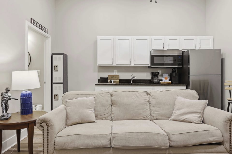 Living Area: Relax in this cozy living space with kitchenette, perfect for unwinding after exploring Churchill Downs and Louisville’s top eateries nearby.