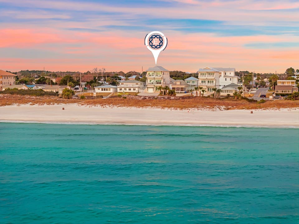 Property location with pristine turquoise waters and sandy shore during golden hour.