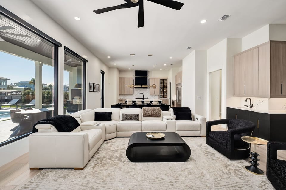 Unwind in your sophisticated open-plan living space with plush seating, modern kitchen, and floor-to-ceiling windows.