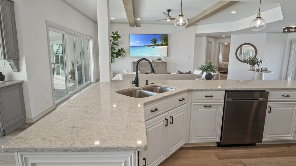 Gourmet kitchen with dual ovens, new stainless-steel Samsung appliances, and waterfront views