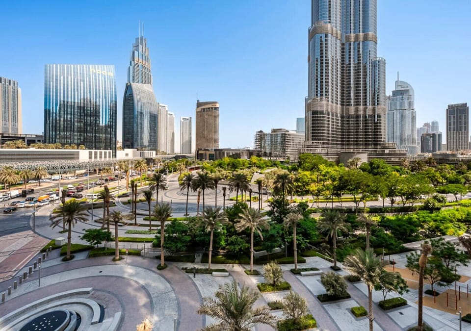 Exterior View: This stunning view captures an expansive, panoramic vista of the modern Downtown Dubai skyline, blending towering skyscrapers with a beautiful, lush green landscape below.