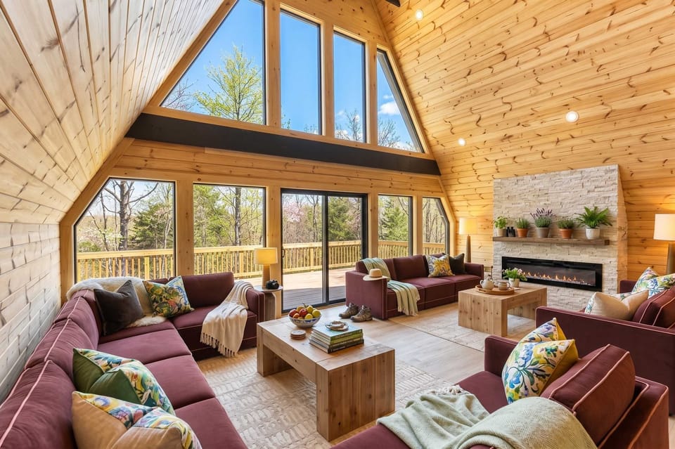 A-Frame Living Room w/ Floor-to-Ceiling Windows & Fireplace