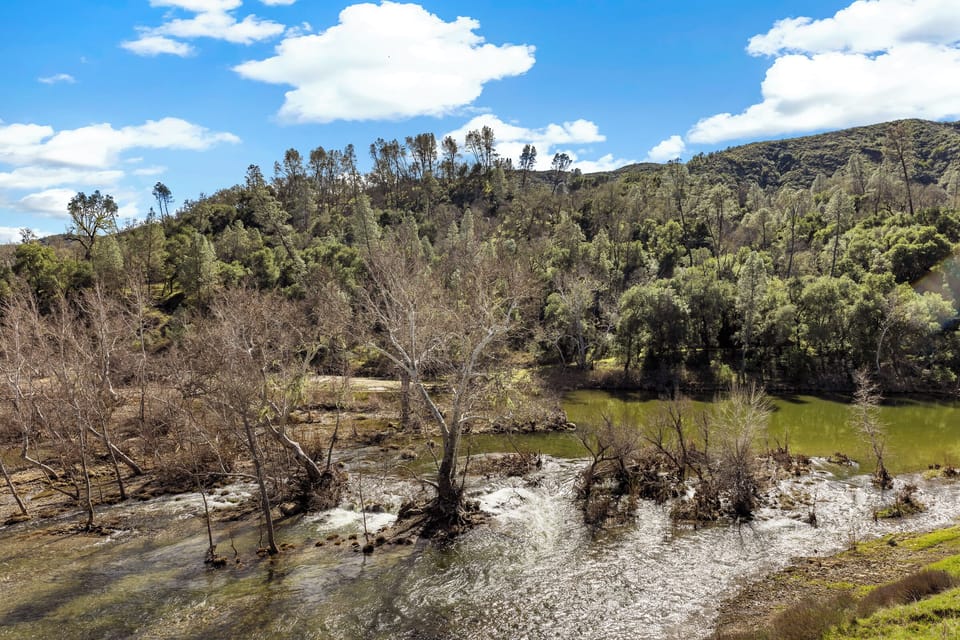 View of the river from the deck, Master Bed, coffee nook and main living area