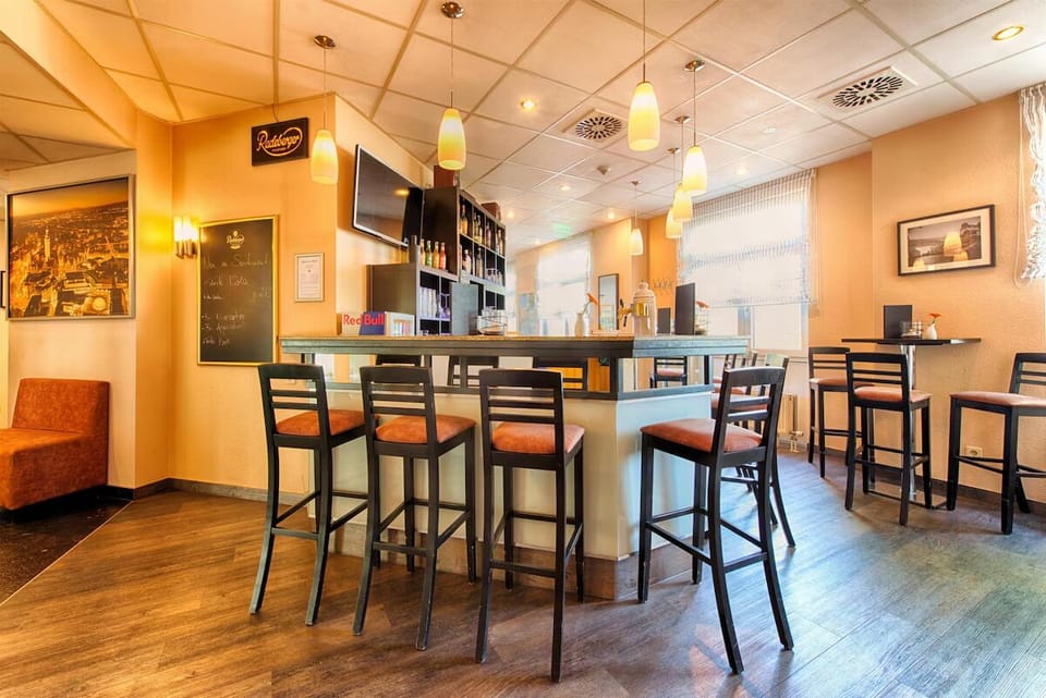Sip a nightcap at the cozy bar under warm lights.