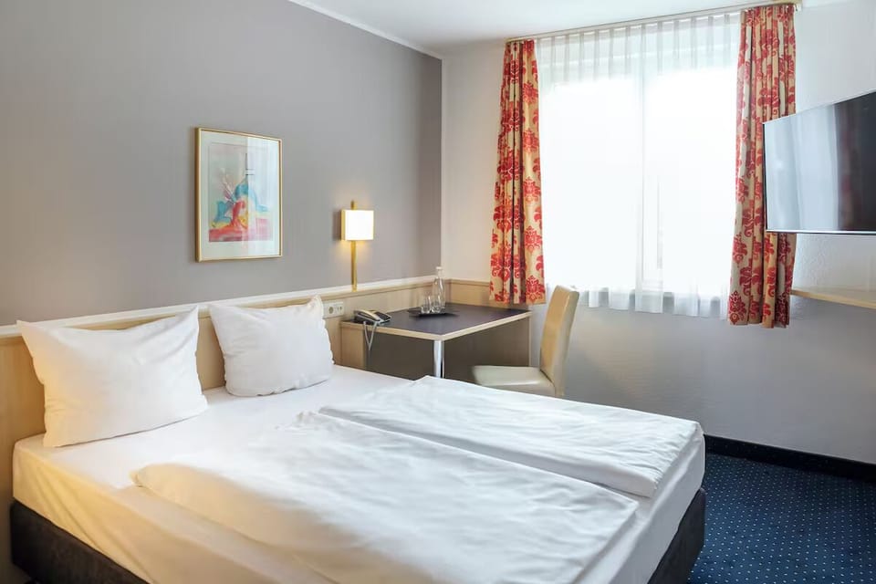 Wake up refreshed in a sunny room with simple, modern comfort.