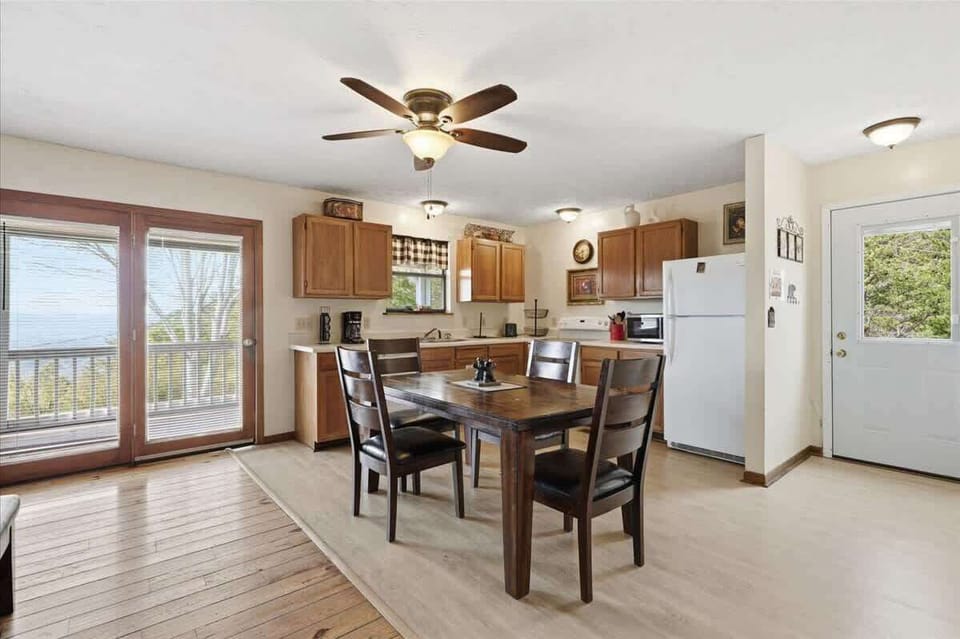 You'll love preparing meals in your fully equipped kitchen with warm wood cabinets, then gathering at the dining table for memorable conversations.