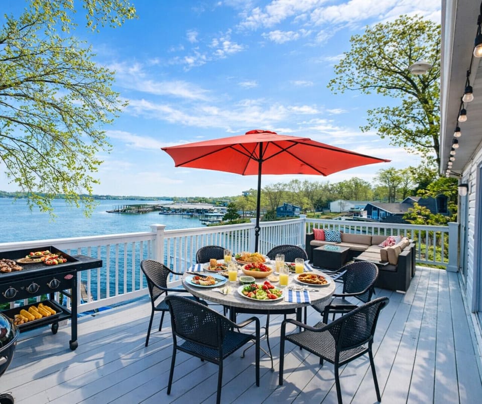 Lakefront vacation home with panoramic water views, spacious deck, outdoor dining & gril