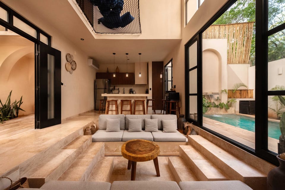 Open-plan living area with glass sliding doors connecting seamlessly to the pool terrace.