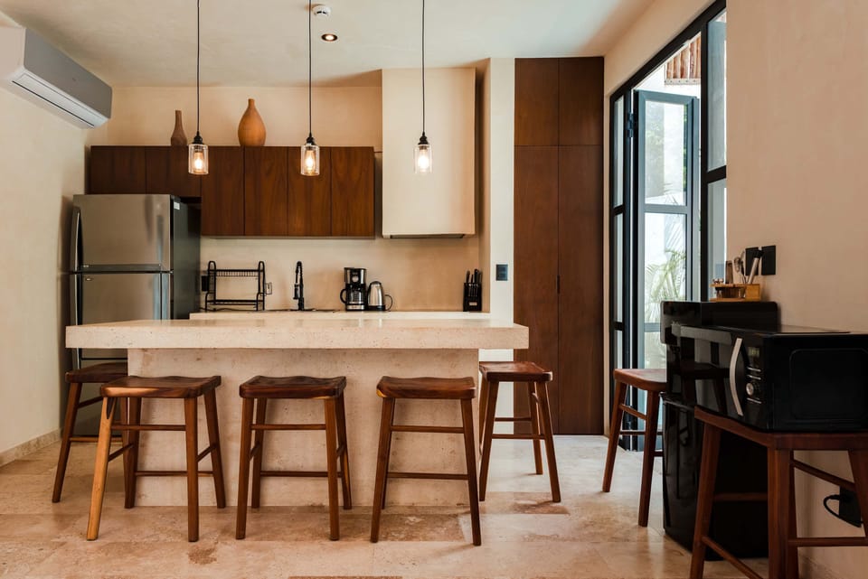 Kitchen island with bar seating, perfect for casual dining overlooking the tropical garden.