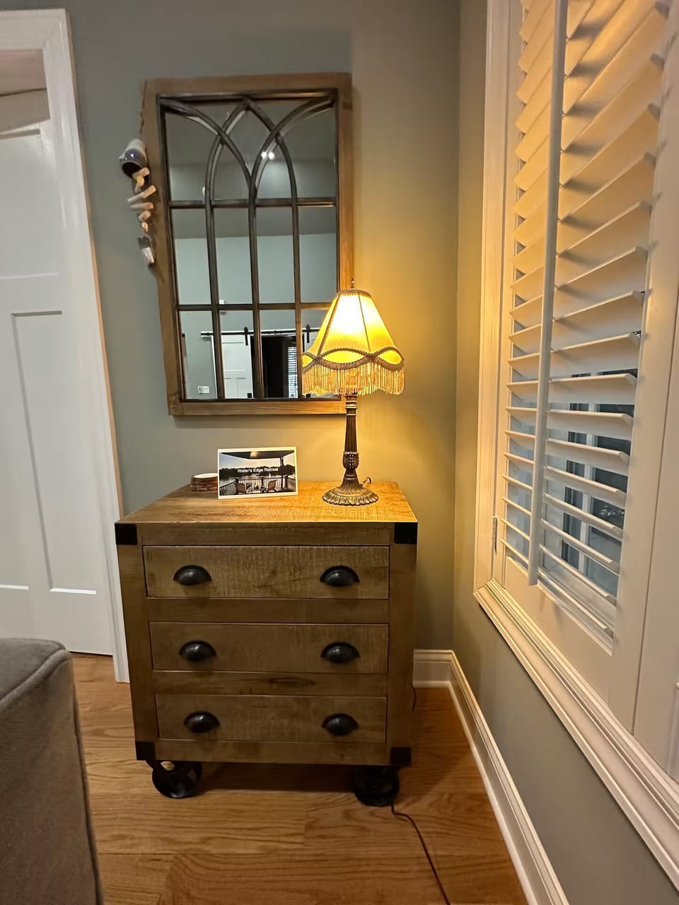 Side table and family room with Tiny House Manual.