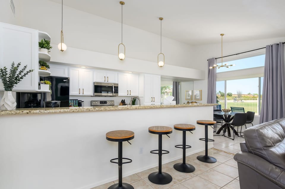 Bright, open-concept kitchen with a breakfast bar. 