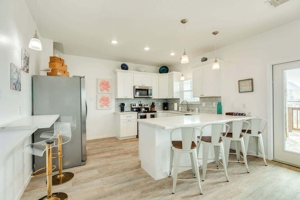 Kitchen view, including bar stools for additional seating 