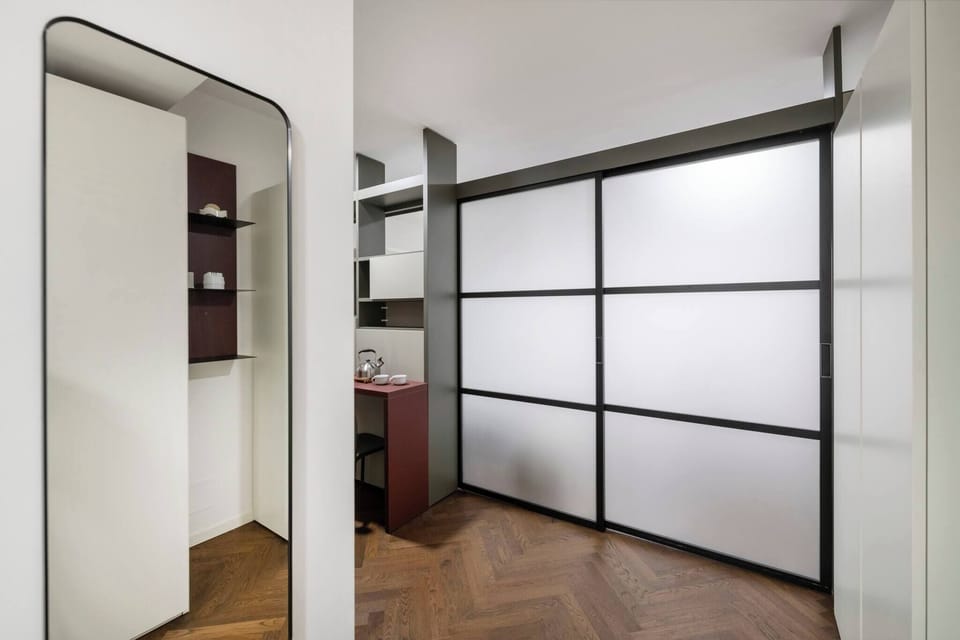 Sliding screen can be used to separate the kitchen from the bed area.