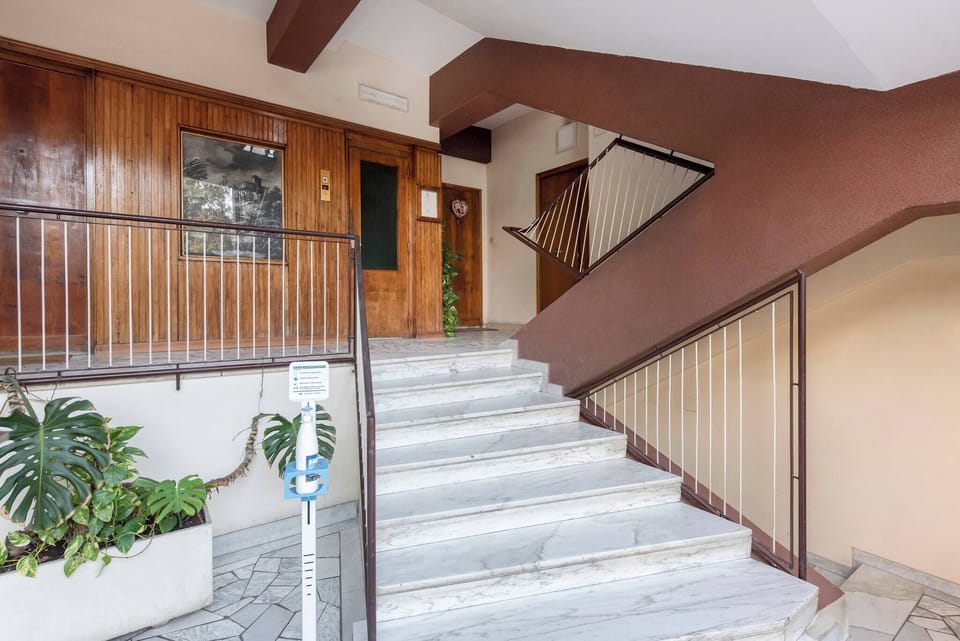 Nice stair case with elevator.
