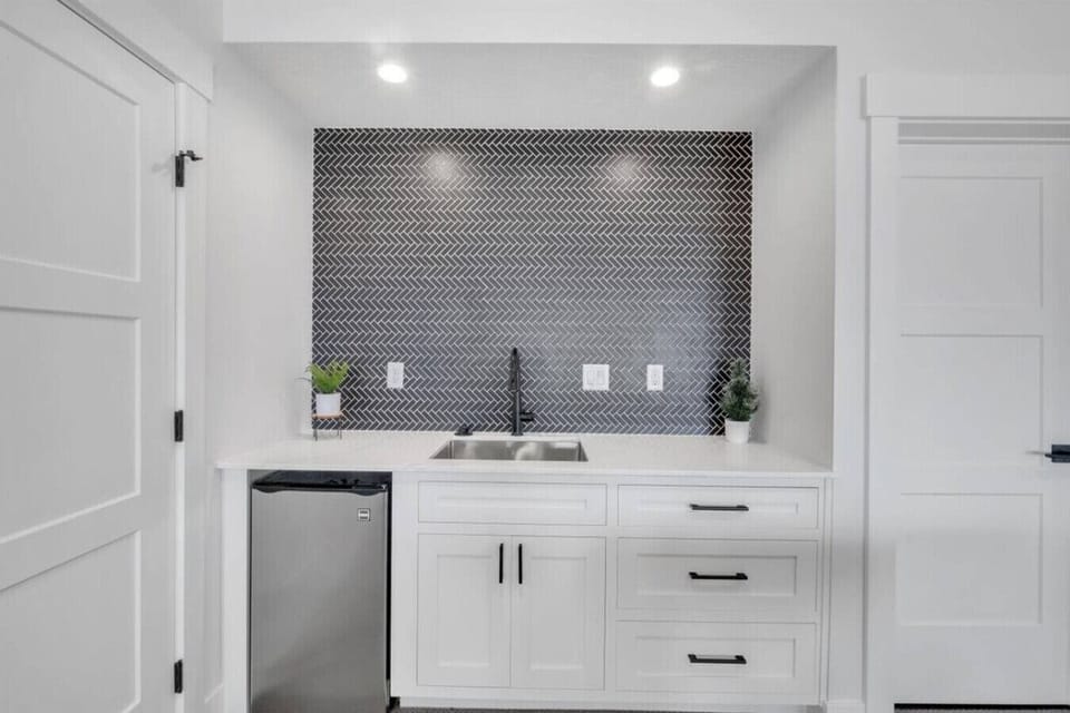 Convenient lower-level wet bar with mini fridge