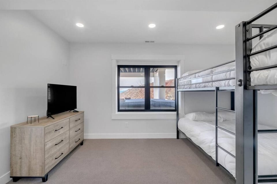 Bunk room with queen bunks and TV