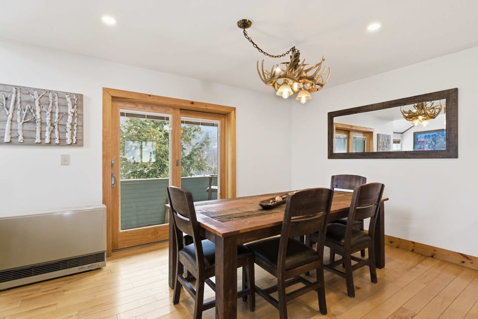 Dining area with seating for six and direct access to the deck for easy indoor-outdoor flow.