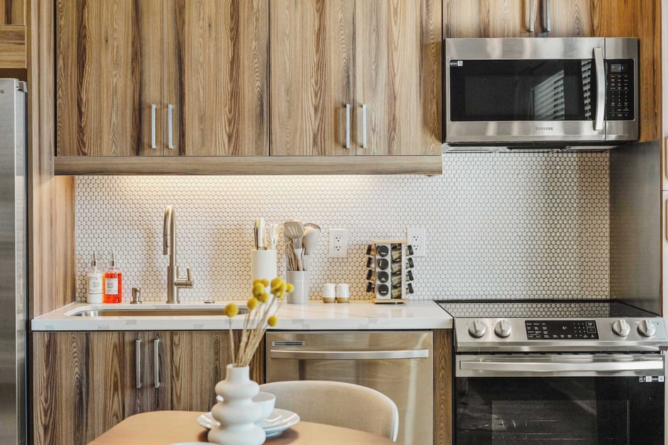 Cook with ease in a modern kitchen featuring full size appliances and ample counter space. Everything is designed to support quick meals or longer stays with minimal effort.