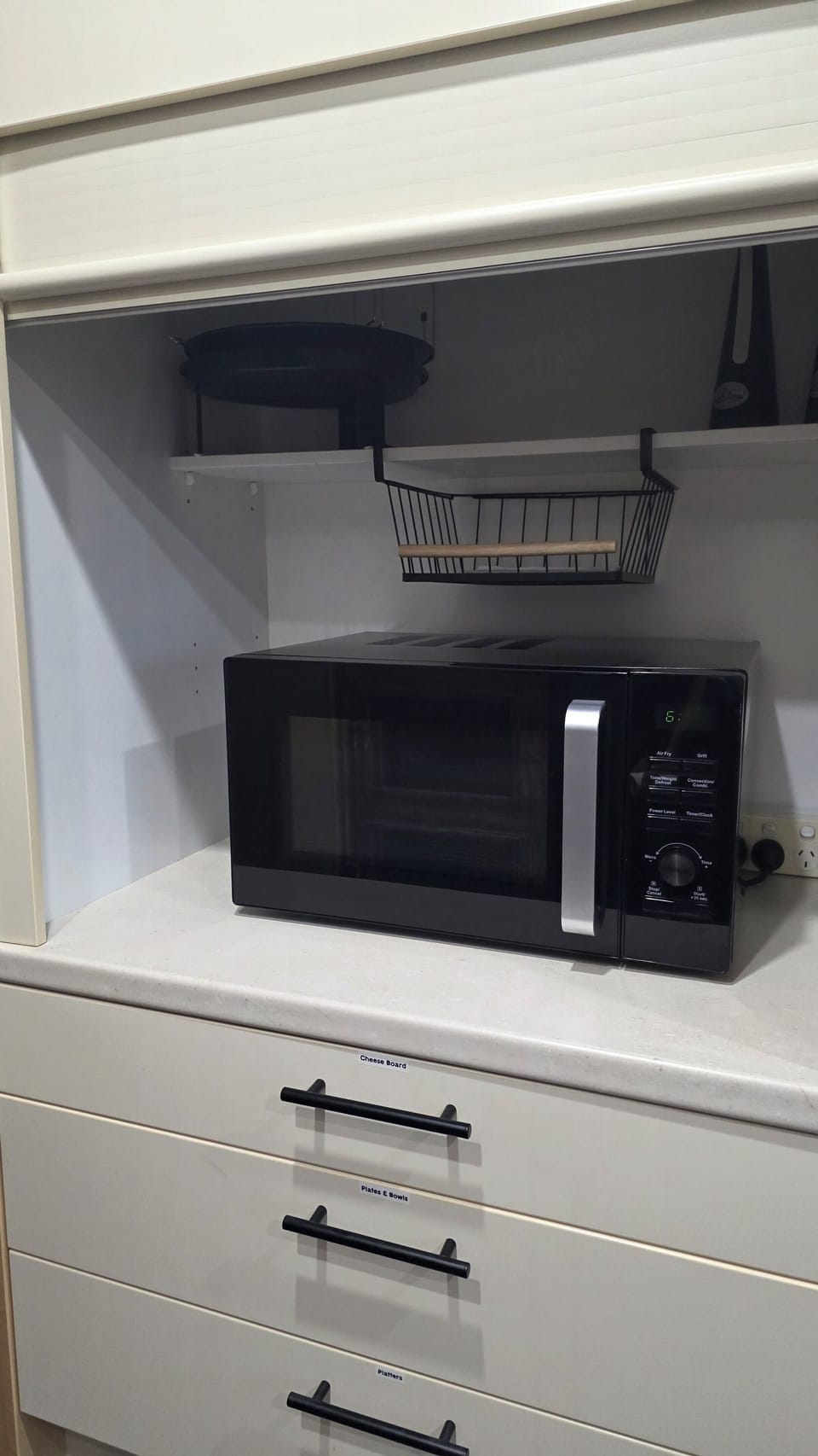 Labelled draws with plenty of cookware and cheese board, serving bowls