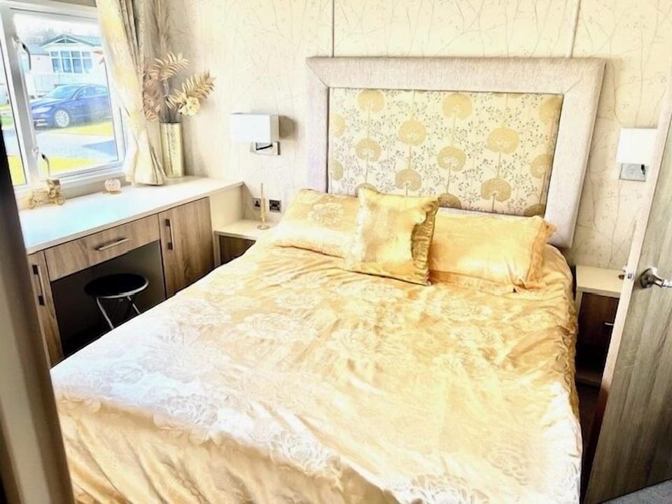 Master bedroom is a vision in gold and comes with vanity area, fitted wardrobes and en-suite WC