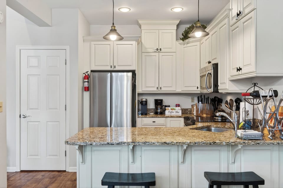 Fully equipped kitchen featuring spacious countertops and stainless steel appliances.